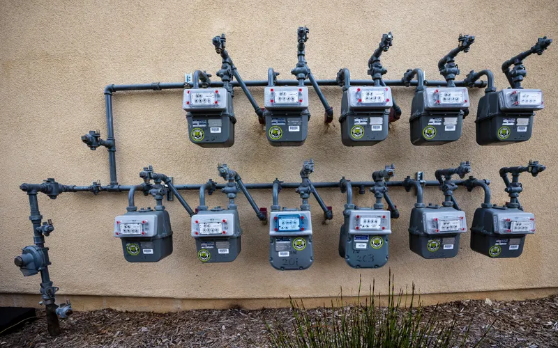 Mehrere Gas- und Stromzähler nebeneinander an einer Außenwand montiert